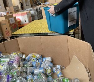 A box full of cans inside the facilities of the Food Bank of Central New York.